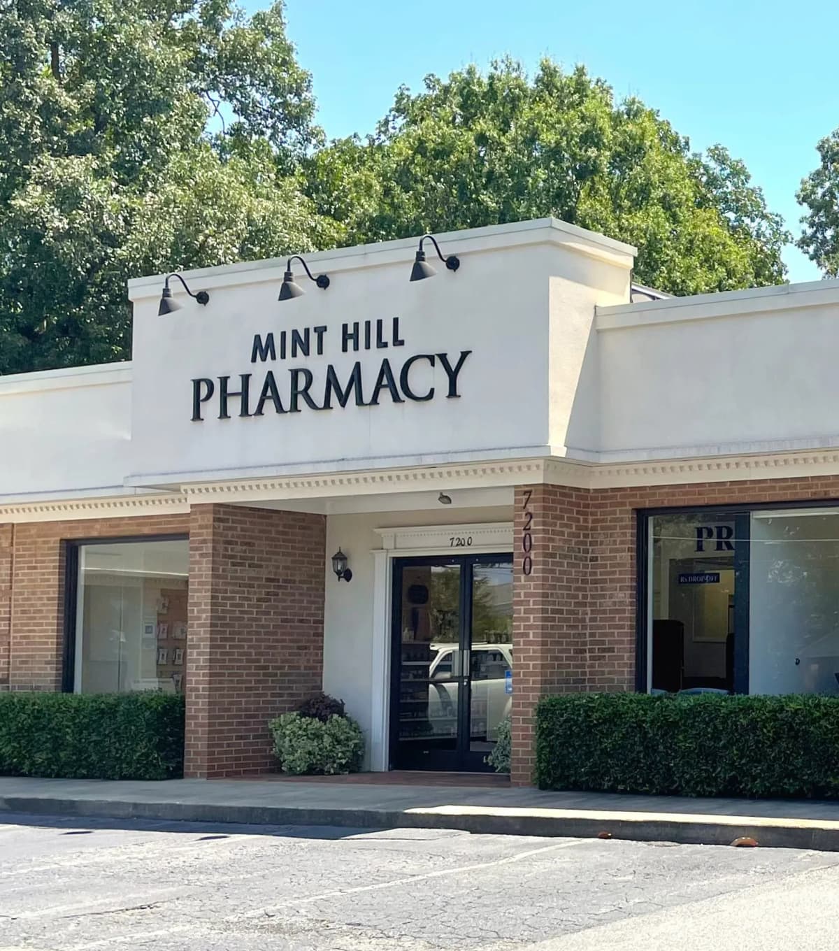 Mint Hill Pharmacy team greeting a patient.