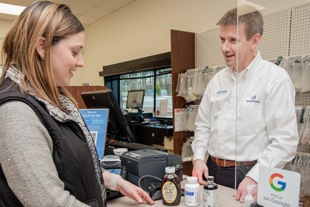 Pharmacist listening to a patient question.