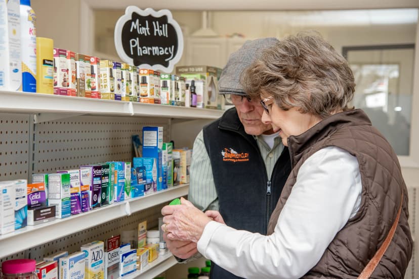 Smiling pharmacist helping customer